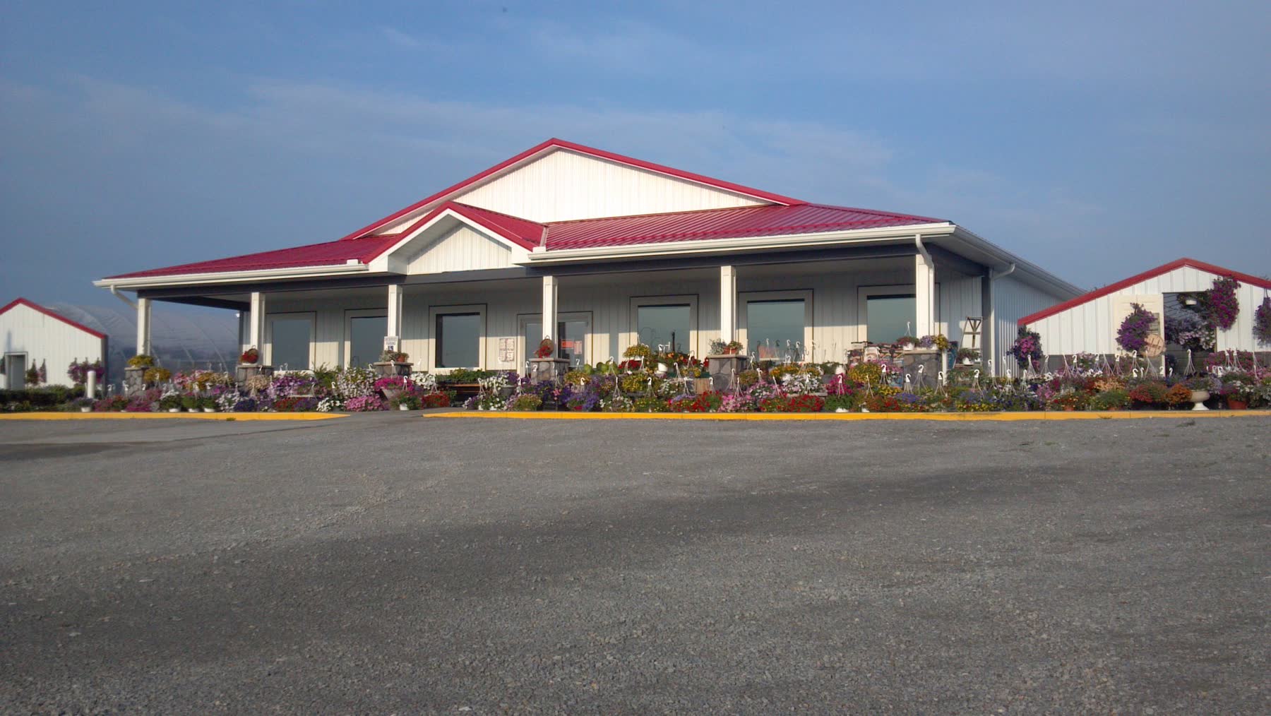Retail building exterior with covered porch and flower displays