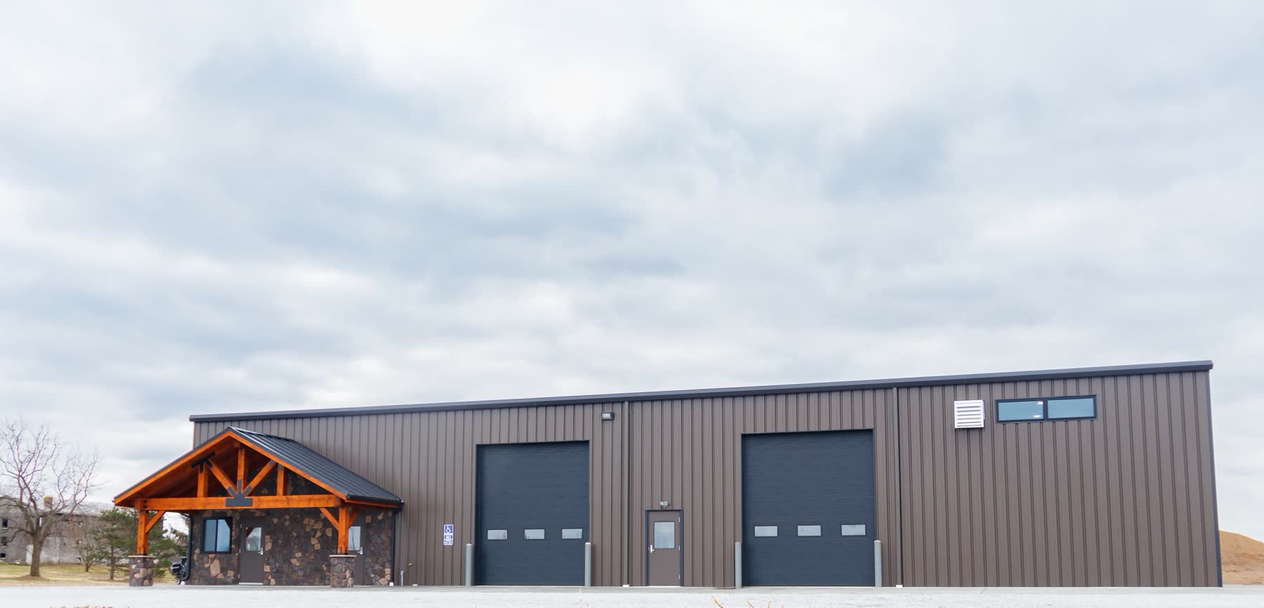 Metal warehouse and manufacturing building with stone entry accent