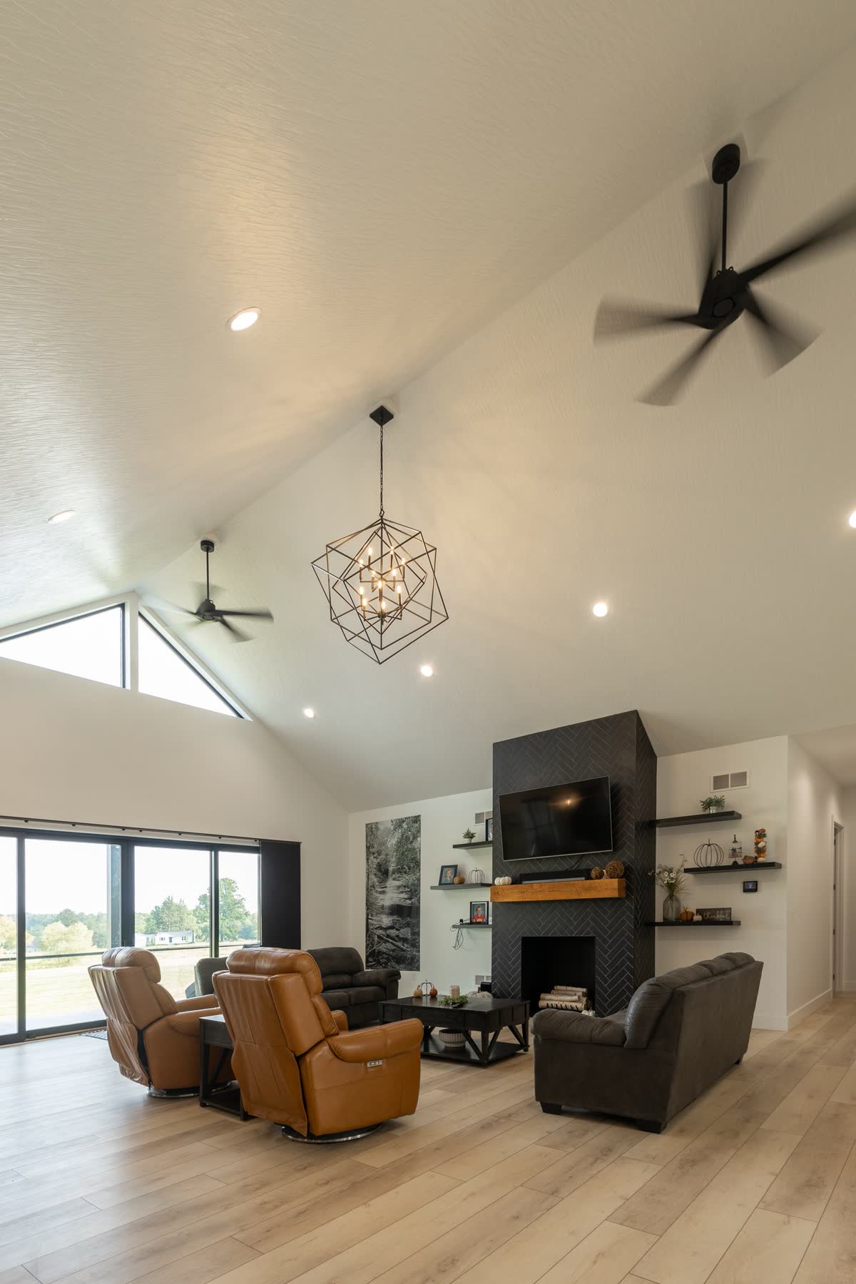 Vaulted great room with fireplace and geometric chandelier