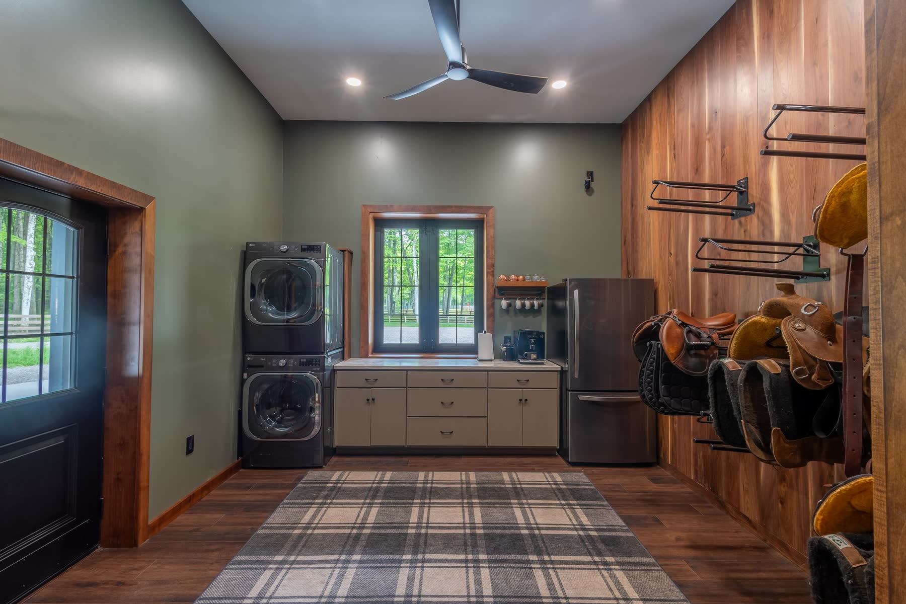 Tack room with saddle racks and laundry area