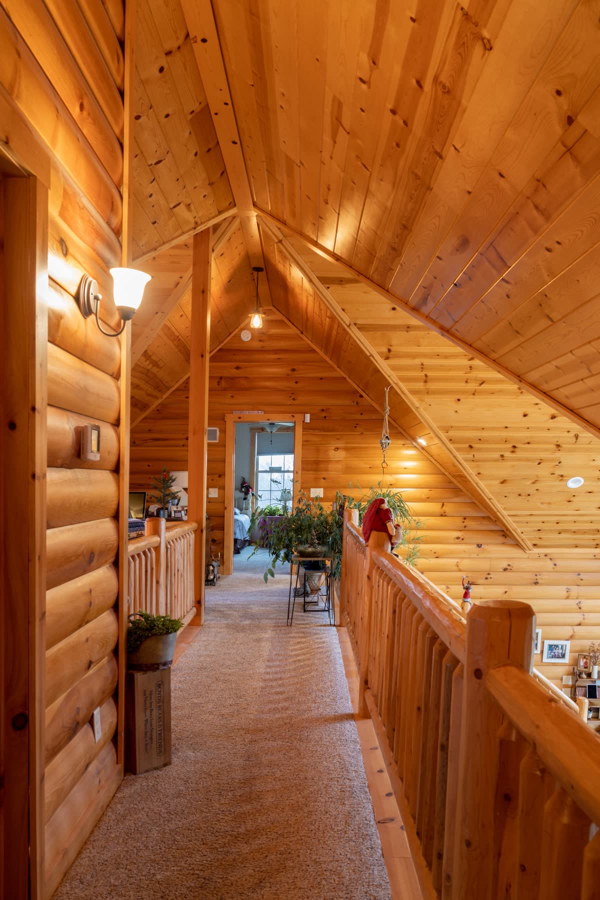 Log home loft hallway with exposed timber railing