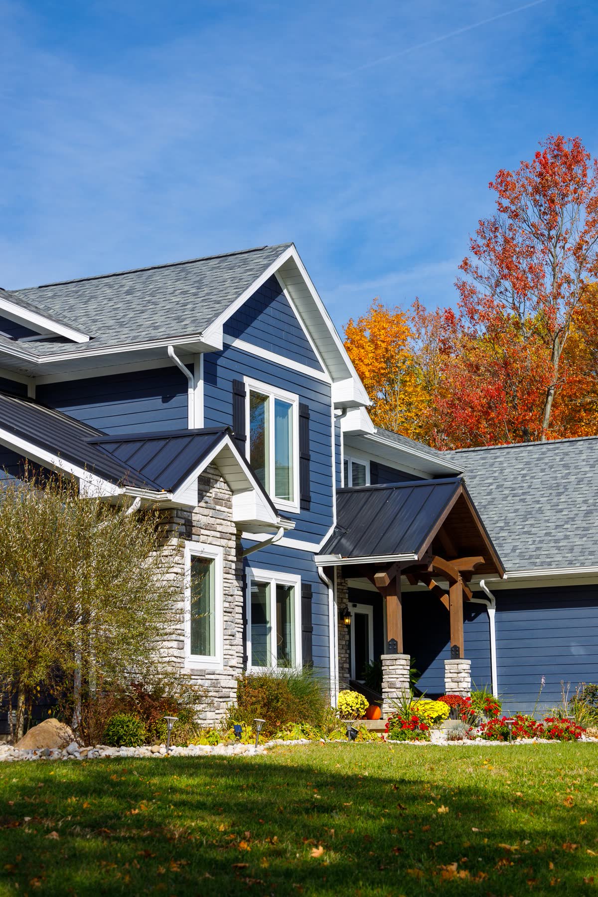 Luxury home exterior with stone accents and timber-frame entry
