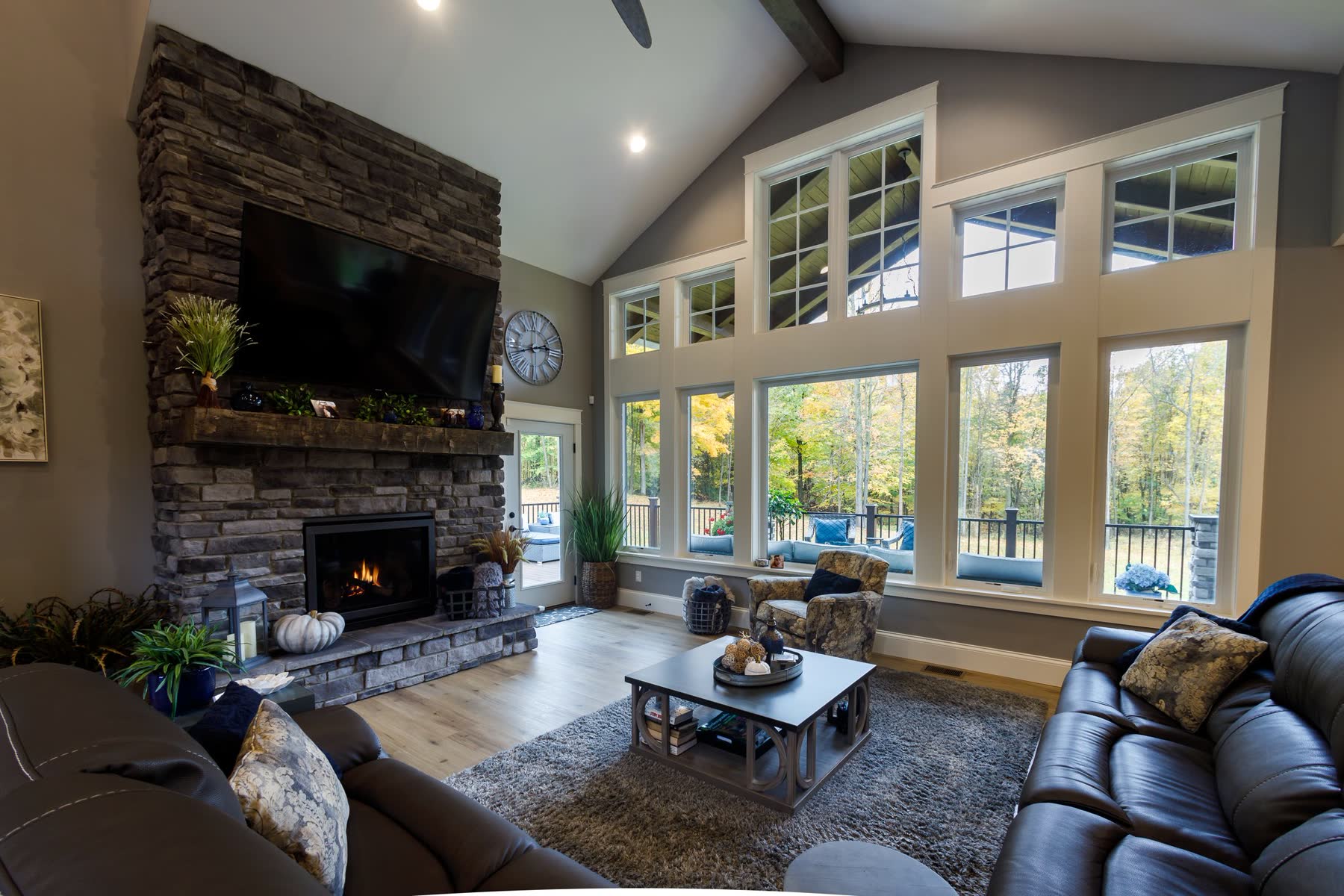 Great room with floor-to-ceiling windows and stone fireplace