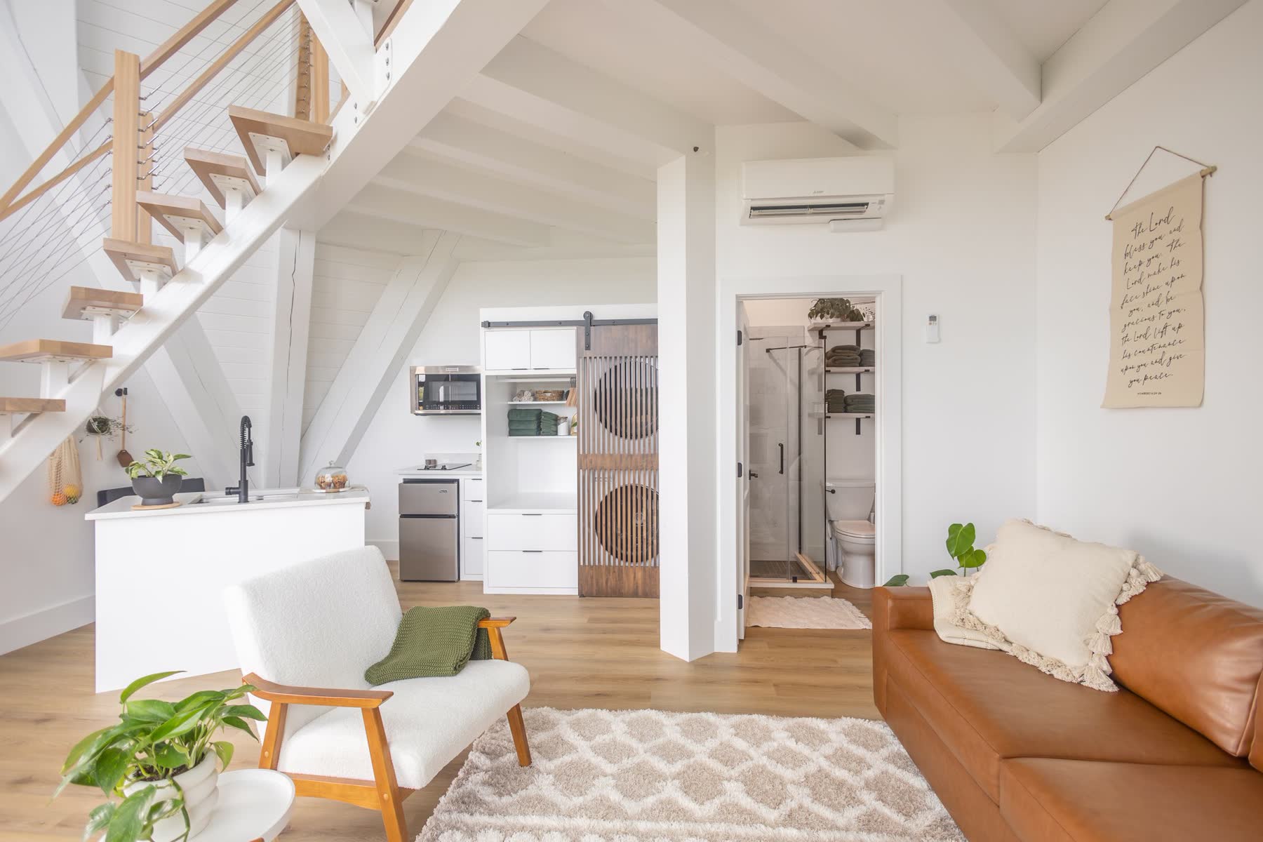 Open loft kitchenette and living space in an A-frame rental