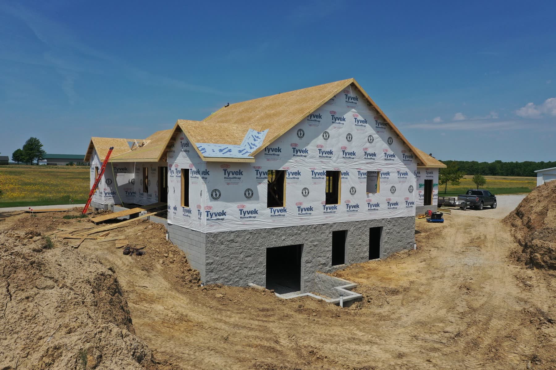 Wayne County custom home framed and wrapped, mid-construction