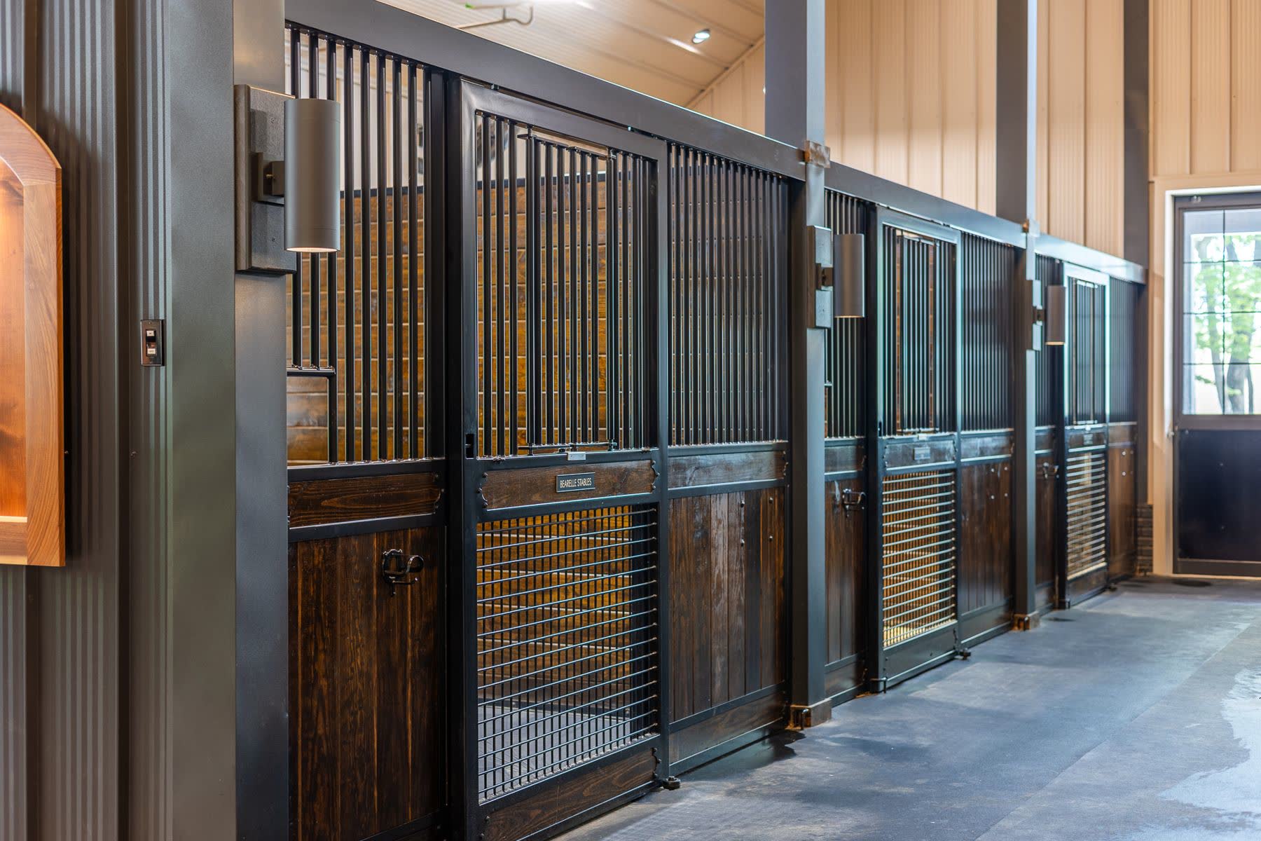 Dark wood stall fronts with steel bars and mesh