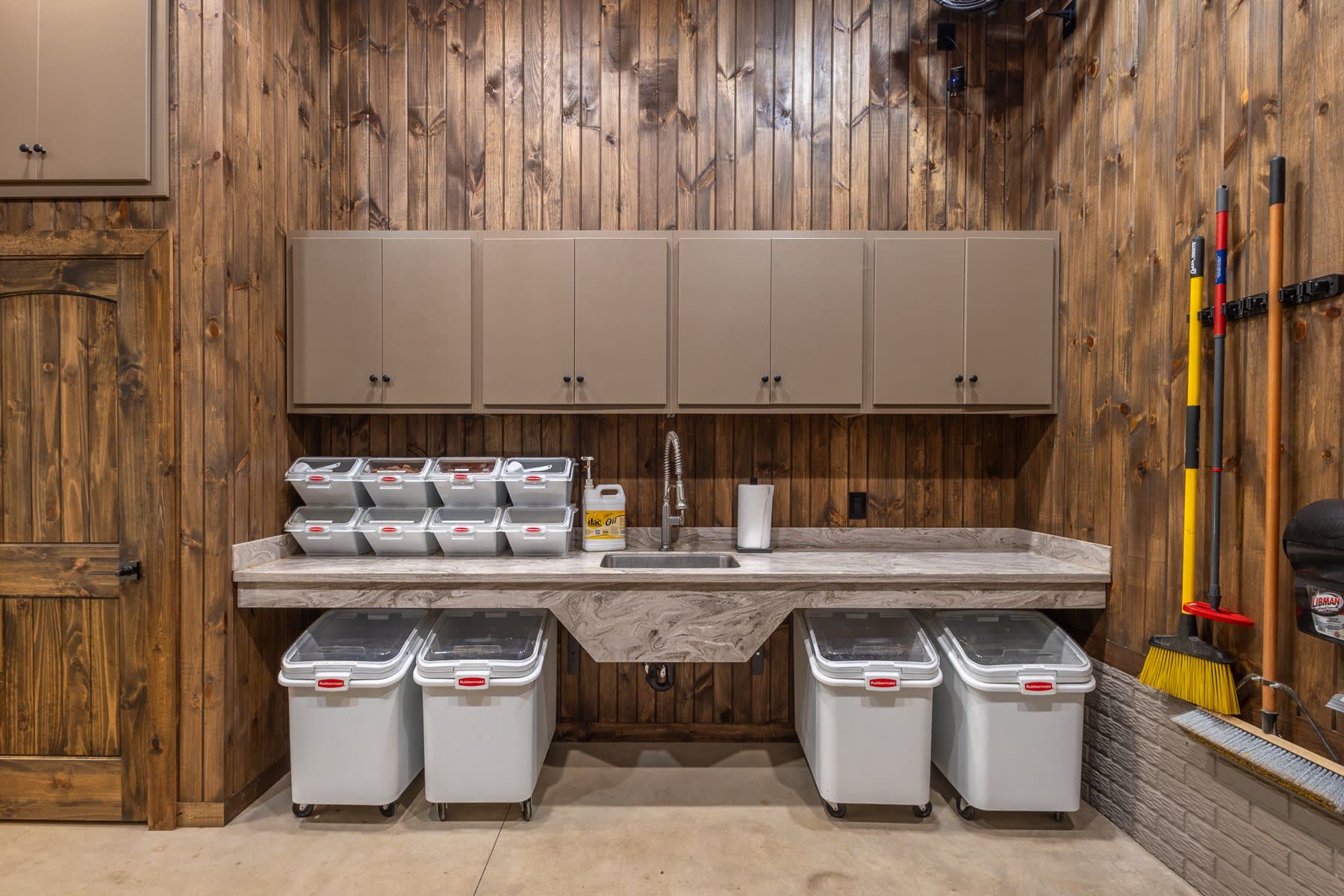 Feed room with cabinets, sink and storage bins